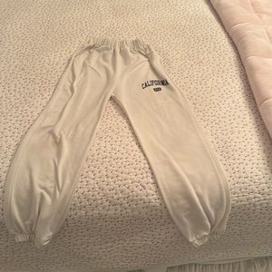 White sweatpants that say California USA on them